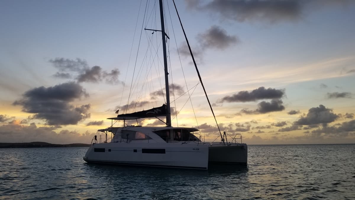 The catamaran at anchor at dusk